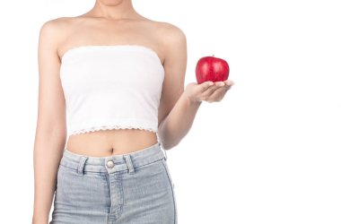 young woman wearing white strapless dress and jeans holding red 