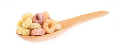close up of colorful cereal and milk with spoon isolated on white background