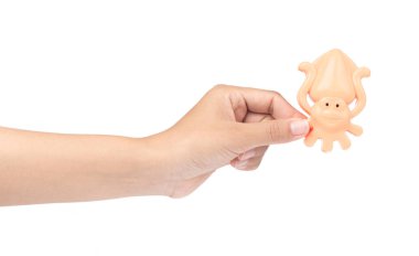 hand holding toy plastic sand molds of sea creature isolated on 