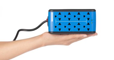 hand holding Automatic Voltage Regulators isolated on white back