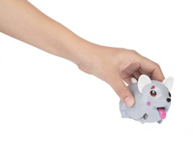 Hand holding clockwork plastic toy isolated on white background