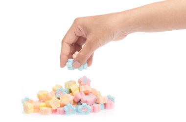 hand holding sweet marshmallow in the shape of flower isolated o