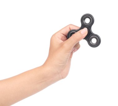 fingers playing a black fidget spinner isolated on a white backg