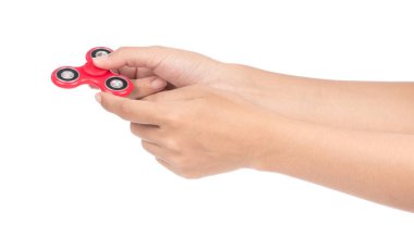 fingers playing a red fidget spinner isolated on a white backgro
