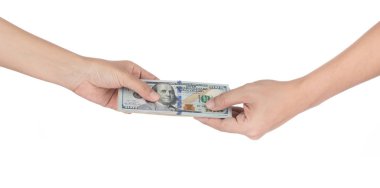 Handing over stacks of cash to other hand isolated on white back