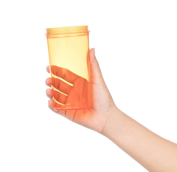 Hand hålla Tom plast orange kopp isolerad på vit backgrou — Stockfoto