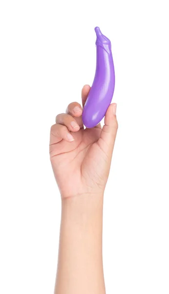 Hand holding plastic toy eggplant isolated on white background — ストック写真