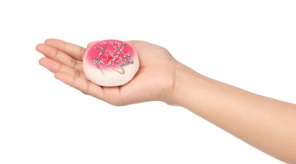 Hand holding a Donut with colorful sprinkles isolated on white b — ストック写真