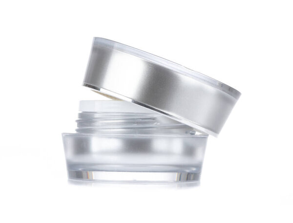 Acrylic cosmetic jar with silver ring isolated on white backgrou