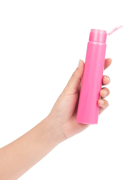 हाथ में सफेद बा पर अलग शैम्पू की गुलाबी प्लास्टिक की बोतल पकड़े हुए — स्टॉक फ़ोटो, इमेज