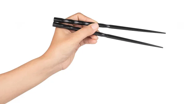 Hand holding wood black of chopsticks isolated on a white backgr — Stock Photo, Image