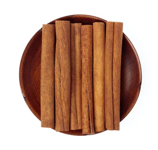 Cinnamon on wood dish isolated on white background — Stock Photo, Image