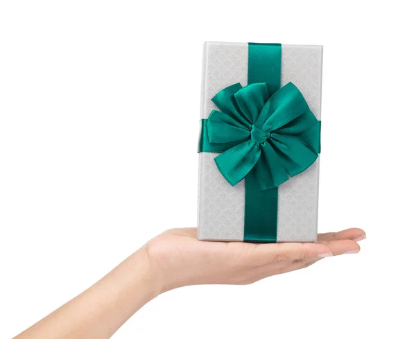 Hand holding a Gift color silver box with green ribbon and bow i — 图库照片