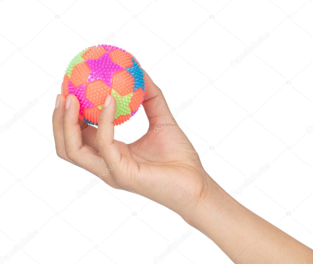 Hand holding Colorful Massage Rubber Ball with Spikes Isolated o