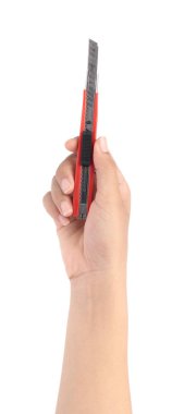hand holding Red cutter knife isolated on white background