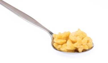 Cereal on spoon isolated on white background.