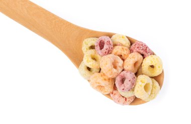 close up of colorful cereal and milk with spoon isolated on white background