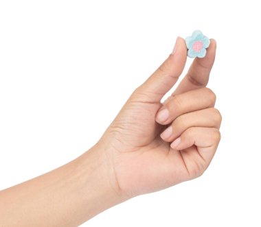 hand holding sweet marshmallow in the shape of flower isolated o