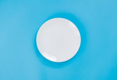A white plate on blue background