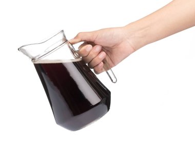 hand holding Cola in a jug with glass isolated on a white backgr