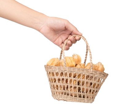hand holding Cape gooseberry in basket isolated on white backgro