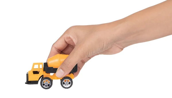 Mão segurando brinquedo caminhão betoneira isolada no branco backgrou — Fotografia de Stock