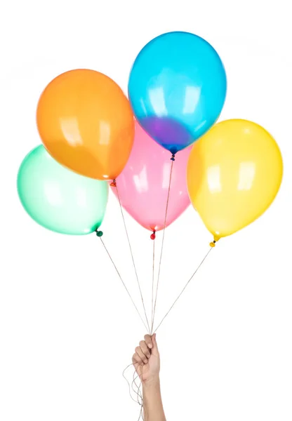 Mano sostiene globos de colores aislados sobre un fondo blanco . — Foto de Stock