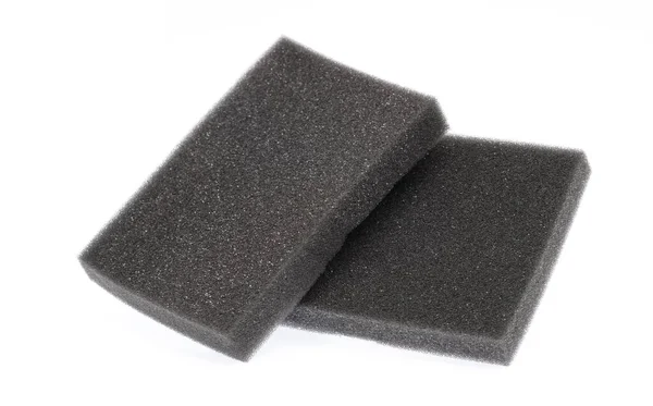 Black sponge isolated on white background — Stok fotoğraf