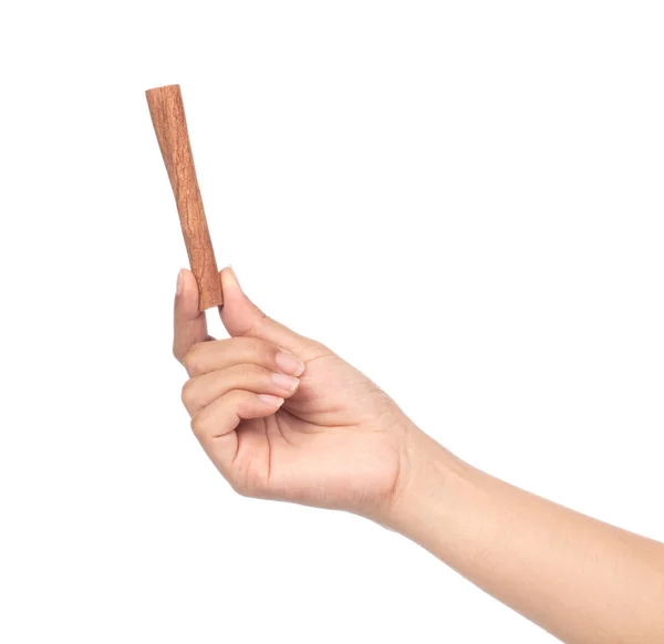 Hand holding cinnamon isolated on white background — Stock Photo, Image