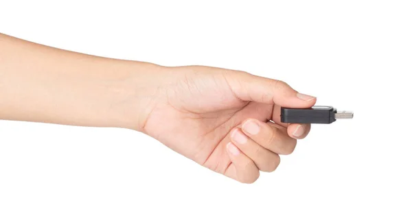 Mão segurando Um preto de memória flash USB isolado em um bac branco — Fotografia de Stock