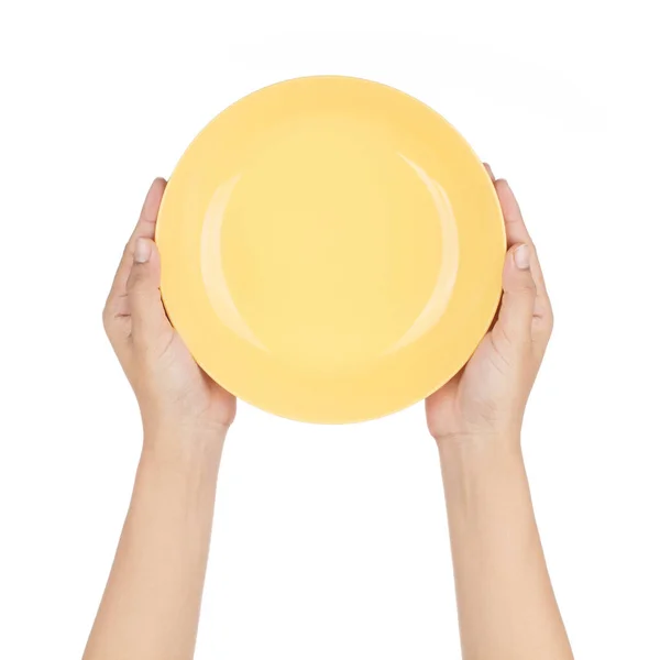 Hand holding Empty yellow plastic plate isolated on white backgr — ストック写真