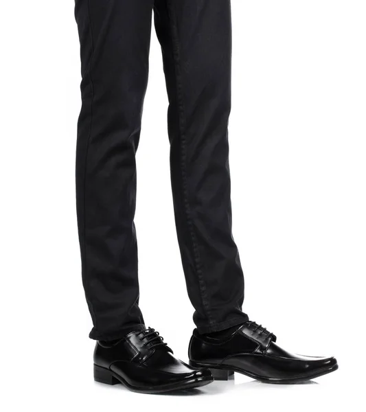Man's feet in black trousers and black shoes isolated on white b — 图库照片