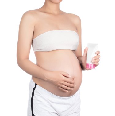pregnant lady rubbing cream on her belly isolated on white backg