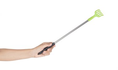 Hand holding Stainless steel itch aid scratch back isolated on a