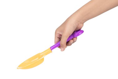 hand holding plastic tool shovel of beach toy isolated on white 