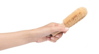 hand holding Wooden body bath brush isolated on white background