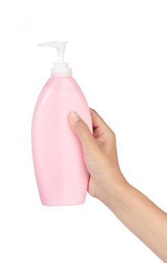 Hand holding Pink plastic bottle with pump isolated on white bac