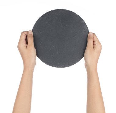 Hand holding Black round stone plate isolated on white backgroun