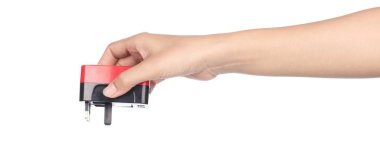 hand holding 3 pin mains plug isolated on white background