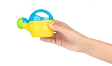close up of toy watering can isolated on white background