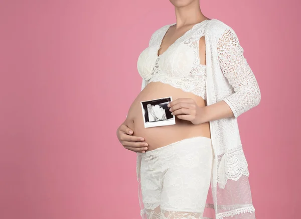 Mujer embarazada sosteniendo ultrasonido exploración en su vientre aislado en —  Fotos de Stock