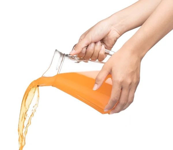 Hand pouring Peach fruit juice isolated on a white background — Stok fotoğraf