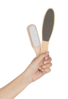 Hand holding stone scrub foot hygiene tool isolated on white bac