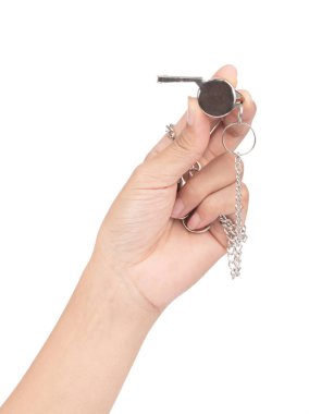 hand holding metal whistle isolated on white background