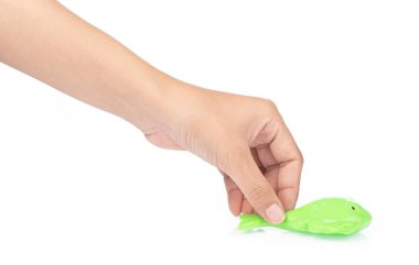 hand holding toy plastic sand molds of sea creature isolated on 