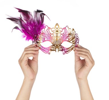 Hand holding beautiful of carnival mask with feather isolated on