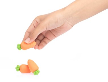 hand holding carrot of rubber erasers isolated on white backgrou clipart