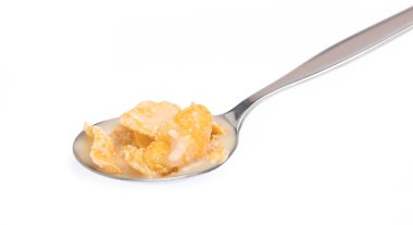 Cereal with milk on spoon isolated on white background.