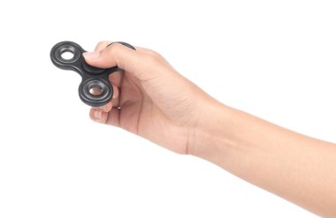 fingers playing a black fidget spinner isolated on a white backg