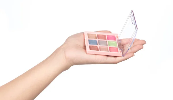Hand holding eyeshadow cosmetics isolated on white background — Stock Photo, Image